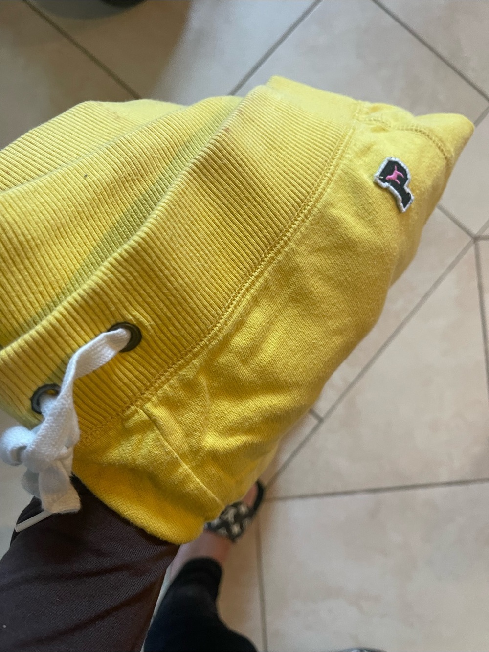 Yellow pants with a small Pink  Logo